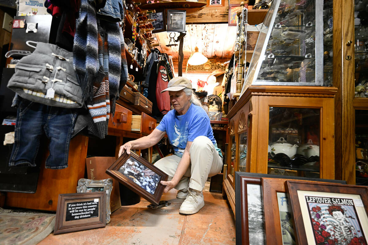 Tracy Turner, owner of the Wynola Junction, looks over pictures that fell from shelves when a e ...