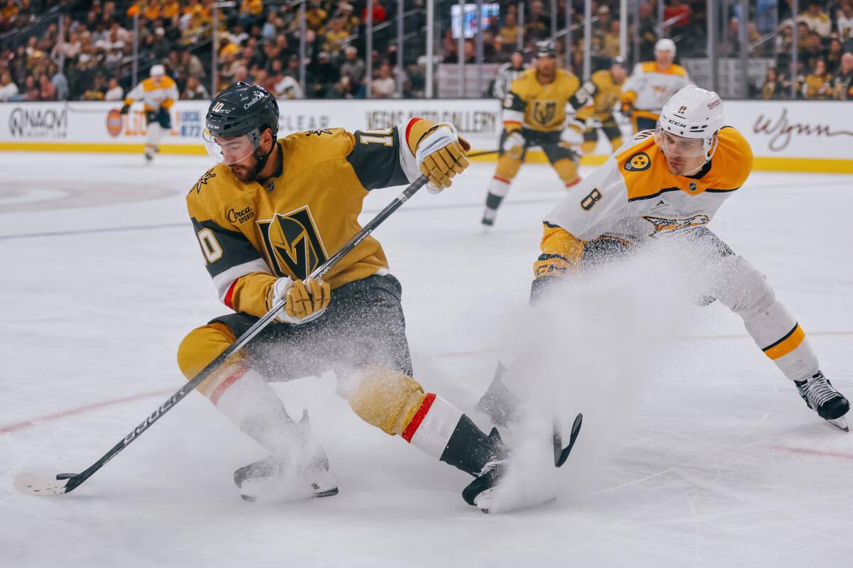 Golden Knights center Nicolas Roy (10) pivots away from Nashville Predators defenseman Andreas ...