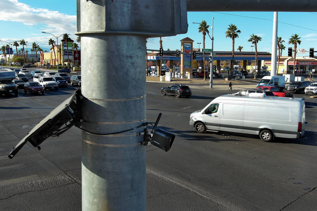A license plate camera scans traffic at the intersection of Sunset Road and Marks Street in He ...