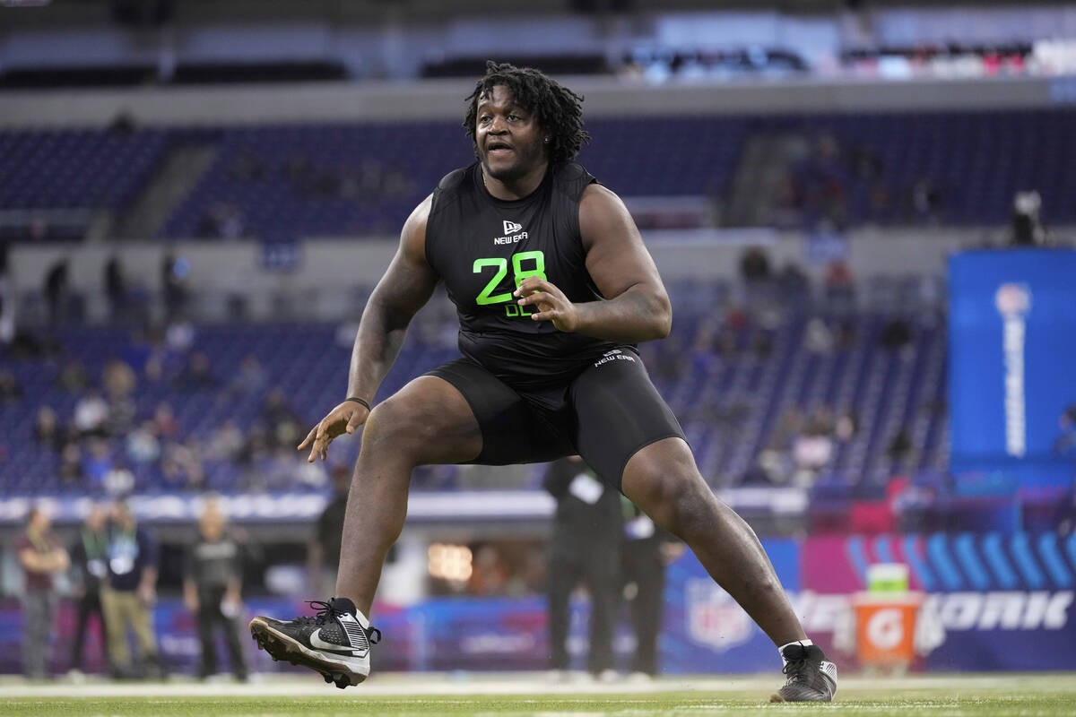 Missouri offensive lineman Armand Membou runs a drill at the NFL football scouting combine in I ...