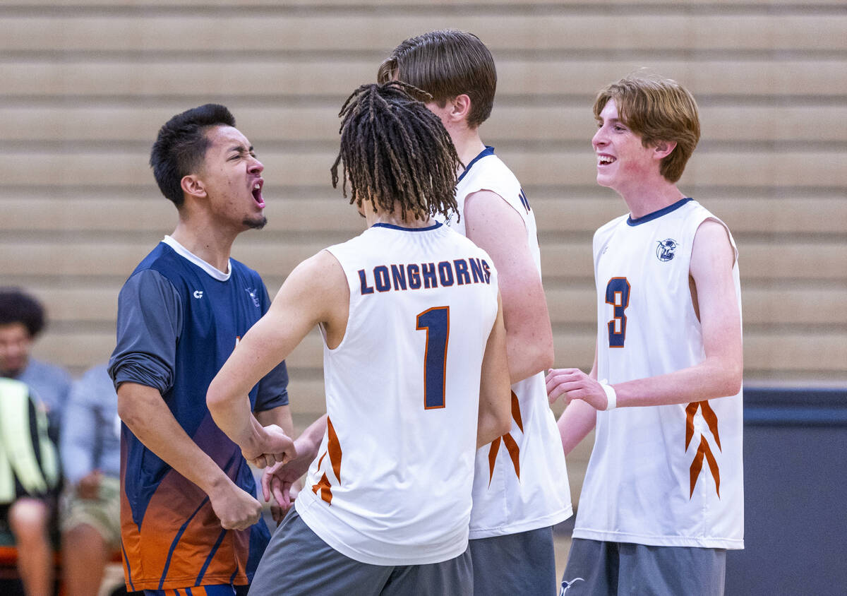Legacy players celebrate a game win against Mojave during their 4A boys volleyball game on Tues ...