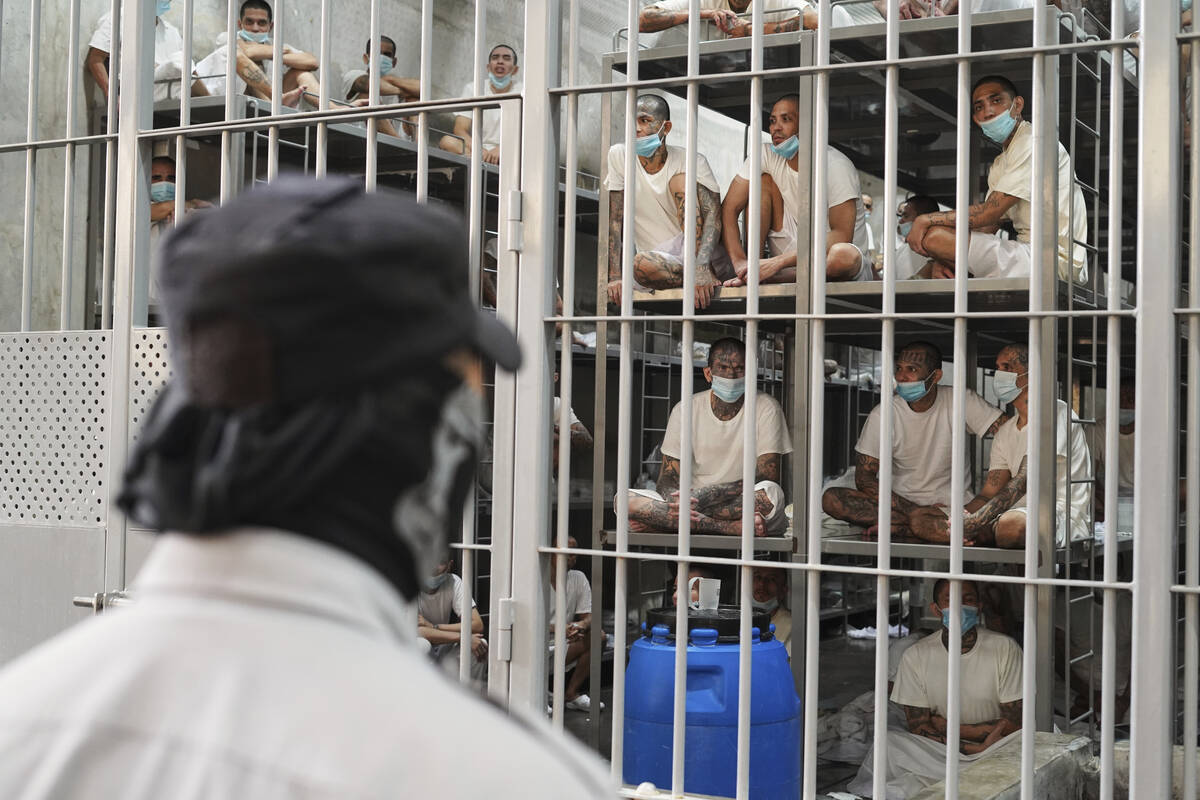 Prisoners look out from their cell at the Terrorist Confinement Center in Tecoluca, El Salvador ...