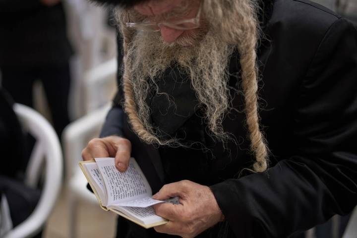 An ultra-Orthodox Jew participates in a blessing during the holiday of Passover, at the Western ...