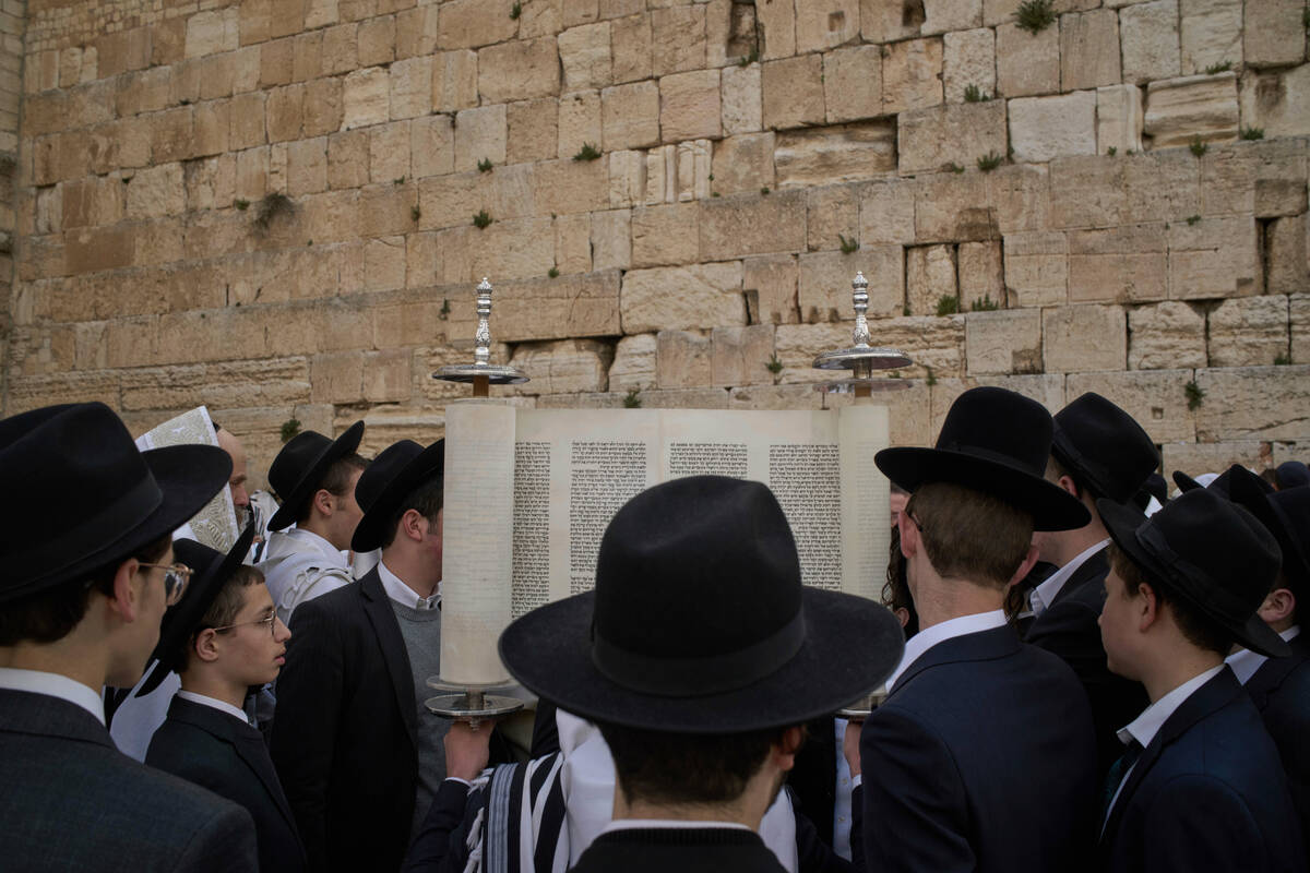 Ultra-Orthodox Jewish men participate in a blessing during the holiday of Passover, at the West ...