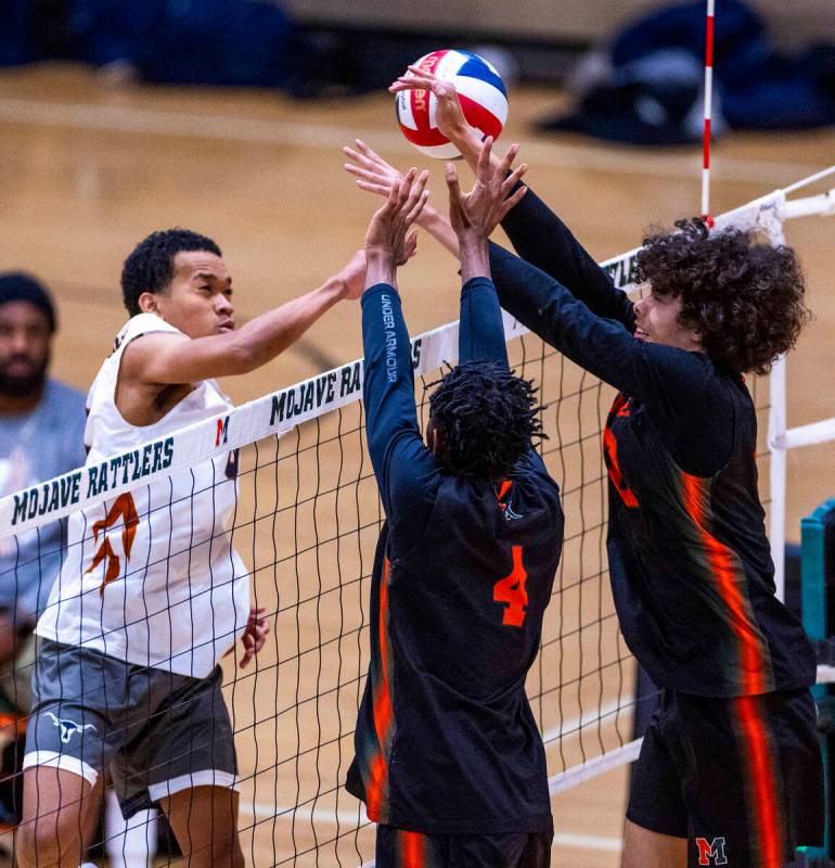 Legacy's Atlys Tapusoa (11) attempts to send the ball past Mojave's Jaion Richards (4) and Kale ...
