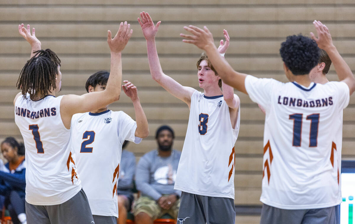 Legacy players celebrate a point against Mojave during their 4A boys volleyball game on Tuesday ...