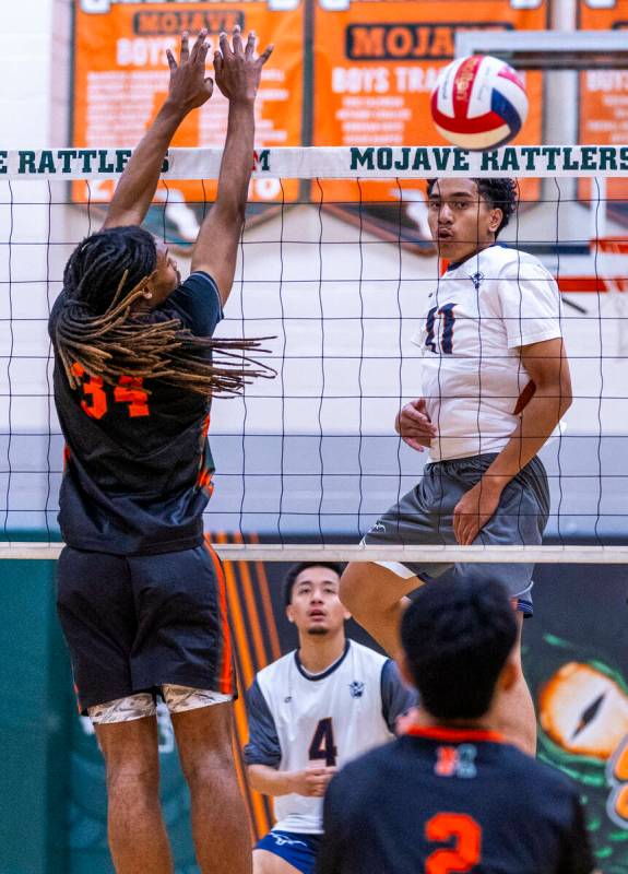 Legacy's Atlys Tapusoa (11) slaps the ball past the defense of Mojave's Quintrell McGee (34) du ...