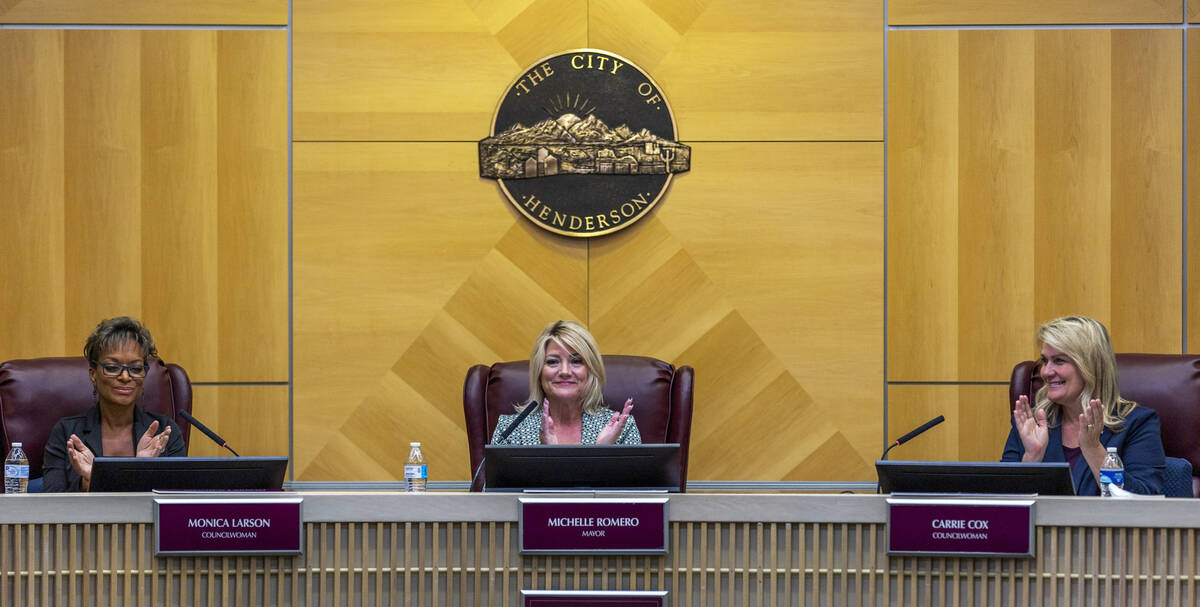 Mayor Michelle Romero, center, Councilwomen Monica Larson, left, and Carrie Cox, right, applaud ...