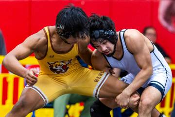 Bonanza's Kanye Ilai-Simio has his leg wrapped up by SLAM's Manuel Saldate during their 138-pou ...