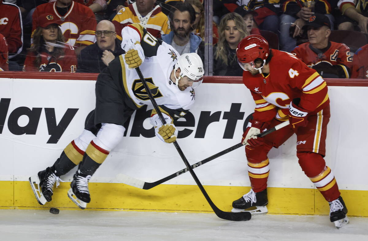 Vegas Golden Knights' Tanner Pearson (70) battles for the puck with Calgary Flames' Rasmus Ande ...