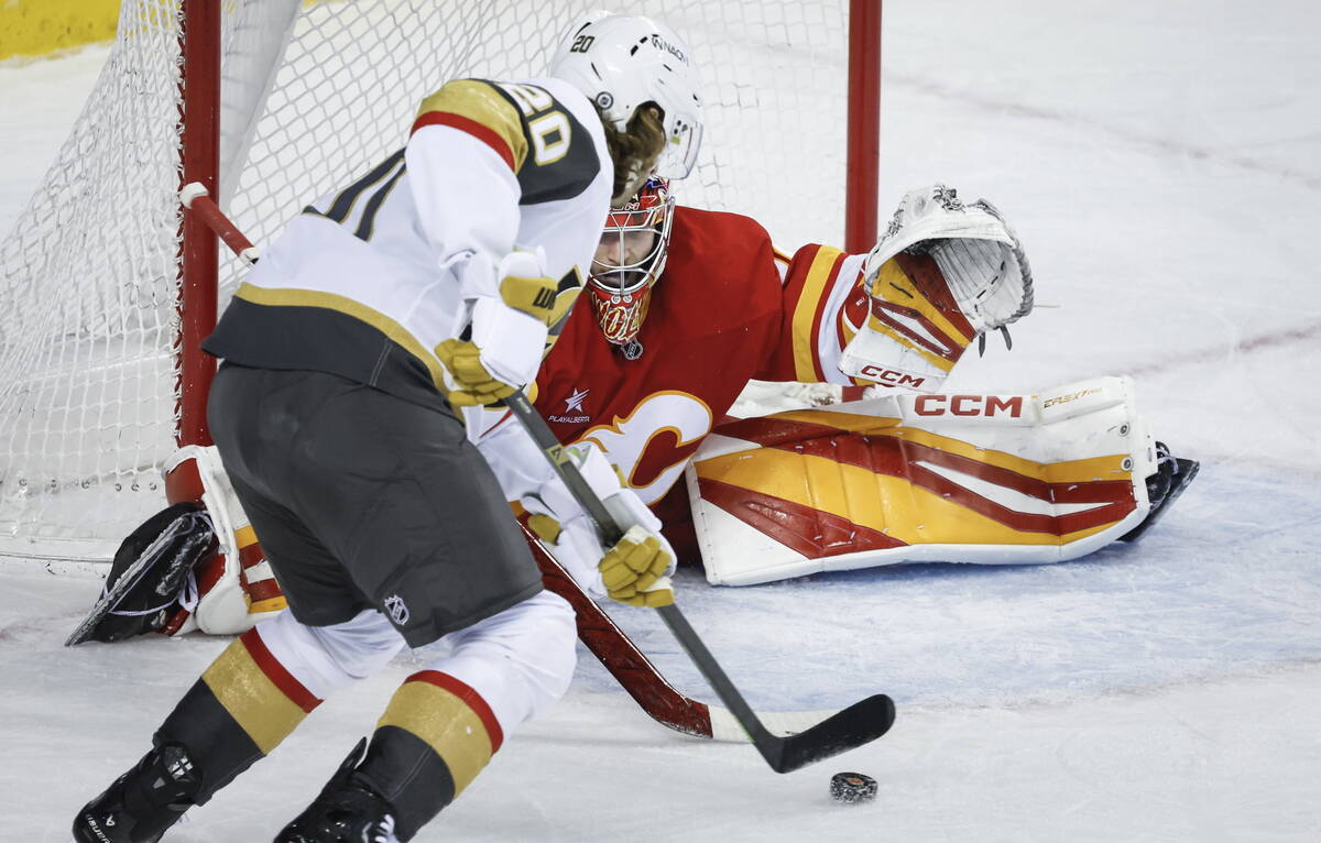 Vegas Golden Knights' Brandon Saad (20) tries to get the puck past Calgary Flames' goalie Dusti ...