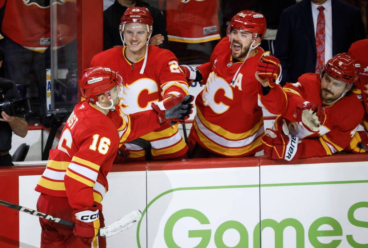 Calgary Flames' Morgan Frost (16) celebrates his game-winning goal with teammates during an ove ...