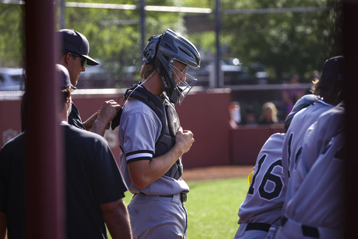 Palo Verde catcher Brady Dallimore gets a mic wired up during a baseball game at Faith Lutheran ...