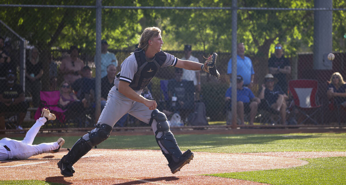 Palo Verde catcher Brady Dallimore makes a catch as a Faith Lutheran player slides into home pl ...