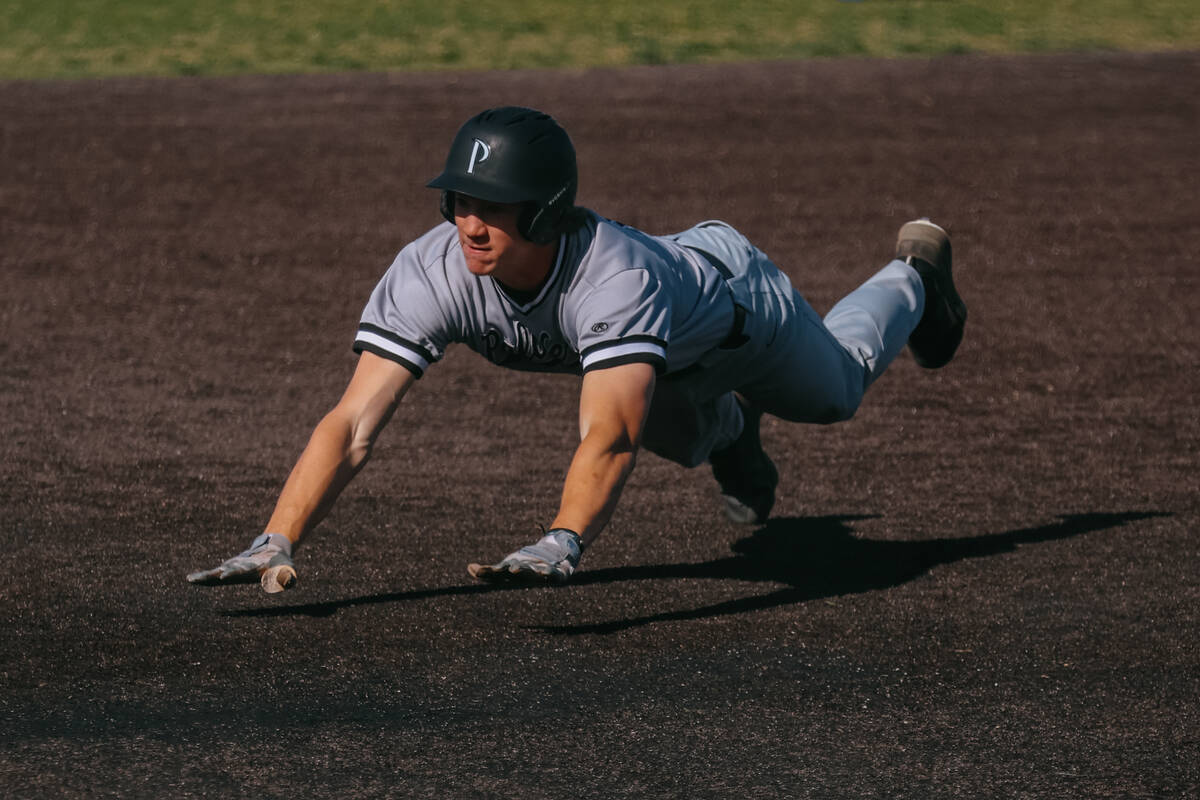 Palo Verde’s Brady Dallimore dives toward third base during a baseball game against Bish ...