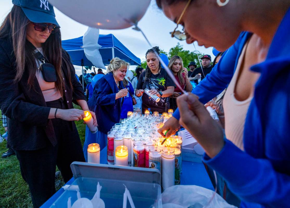 Candles are lit for Tabatha Tozzi, 26, recently killed and now honored during a vigil with fami ...