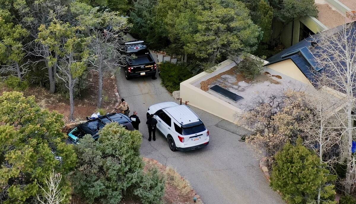 FILE - Law enforcement officials talk outside the home of actor Gene Hackman on Feb. 27, 2025 i ...