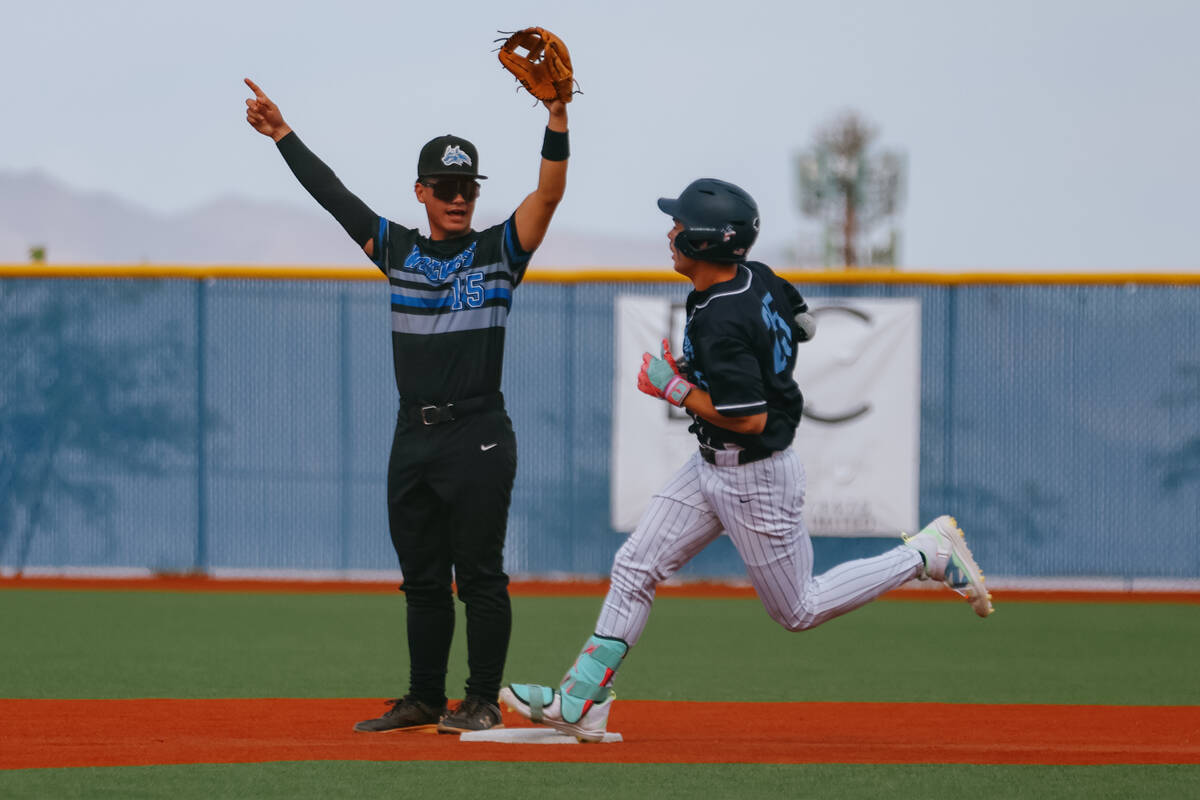 Basic second baseman Lyndon Lee (15) celebrates as Centennial’s Terrell Otis (25), whose ...