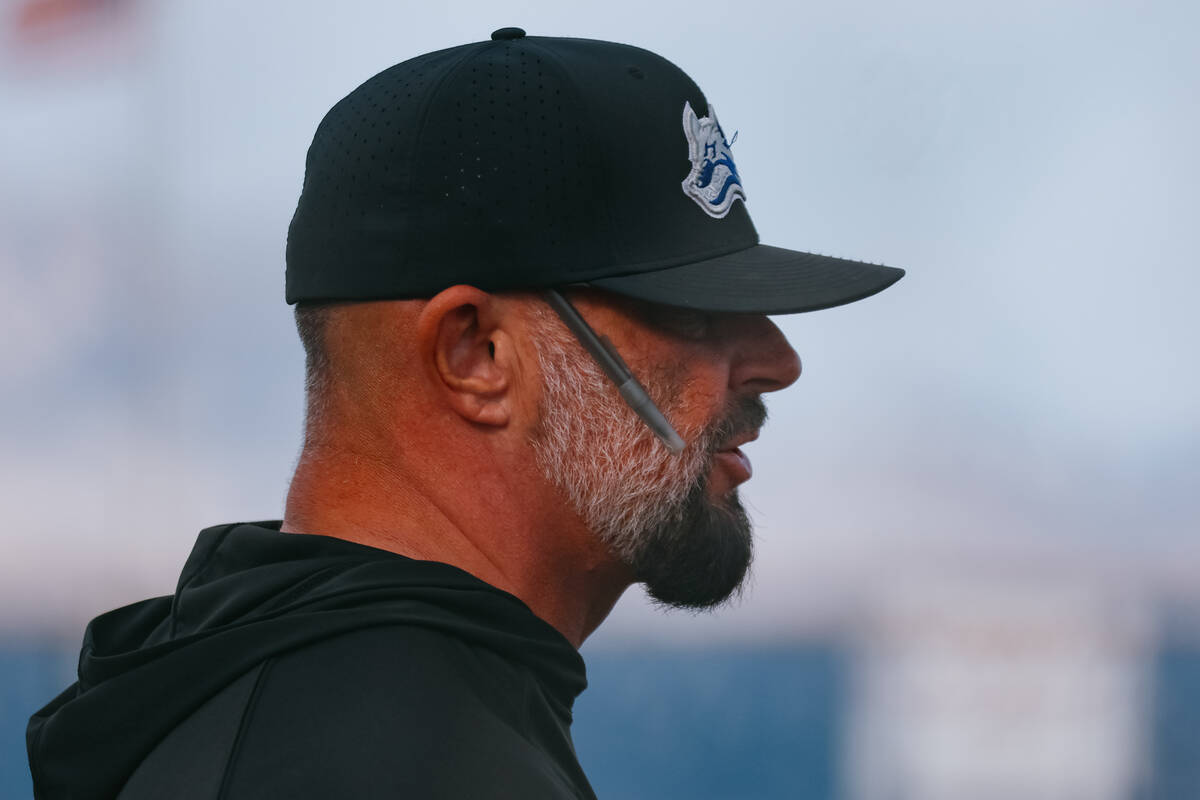 Basic head baseball coach Gino DiMaria talks with other coaches on the sidelines between inning ...
