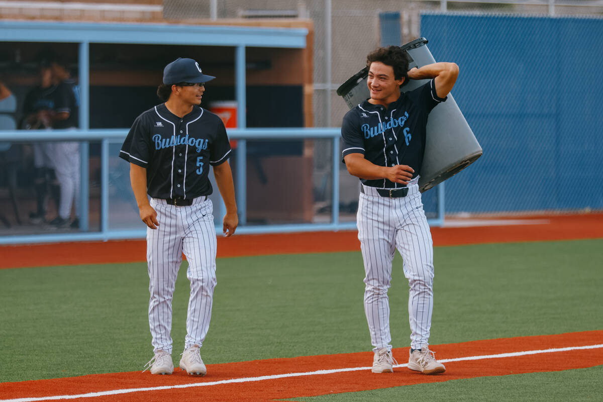 Centennial’s Noa Oyadomari (5) and Kyle Kono (6) chat with each other as they help clean ...