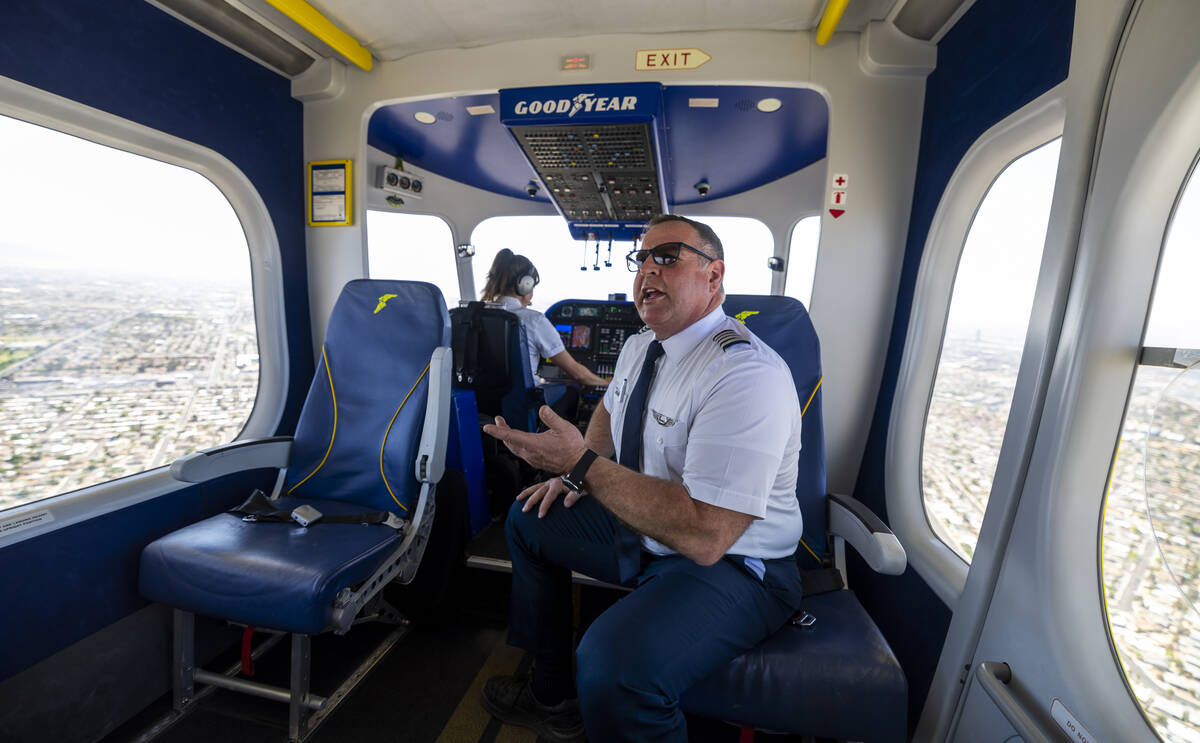 Pilot Joe Erbs talks about the Goodyear blimp as pilot Taylor Deen maneuvers it along the I-15 ...