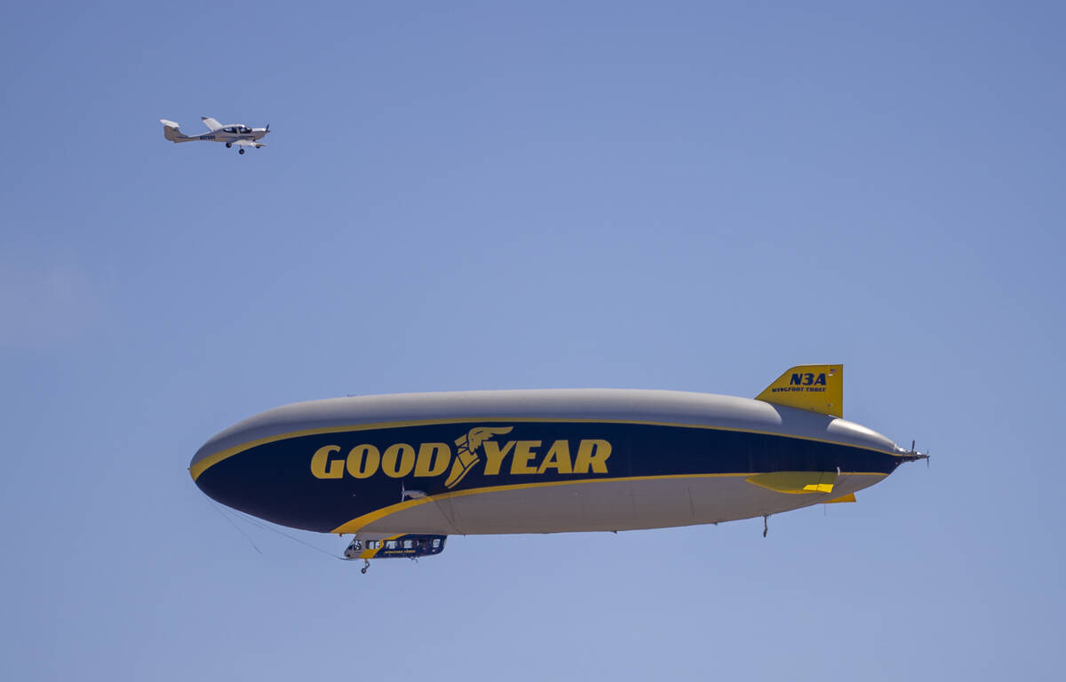 The Goodyear blimp and small plane pass each other as it approaches the North Las Vegas Airport ...