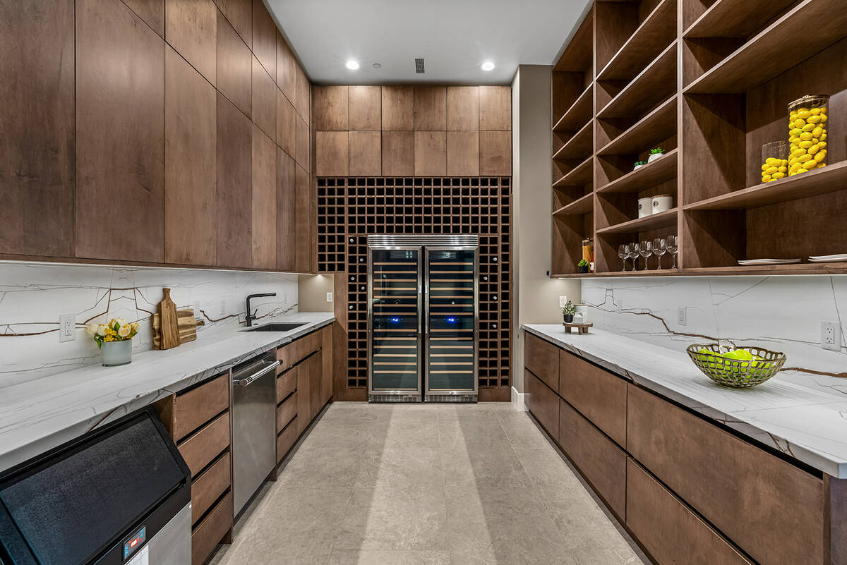 A large butler’s pantry has two wine coolers, a refrigerator/freezer, an ice maker, a dishwas ...