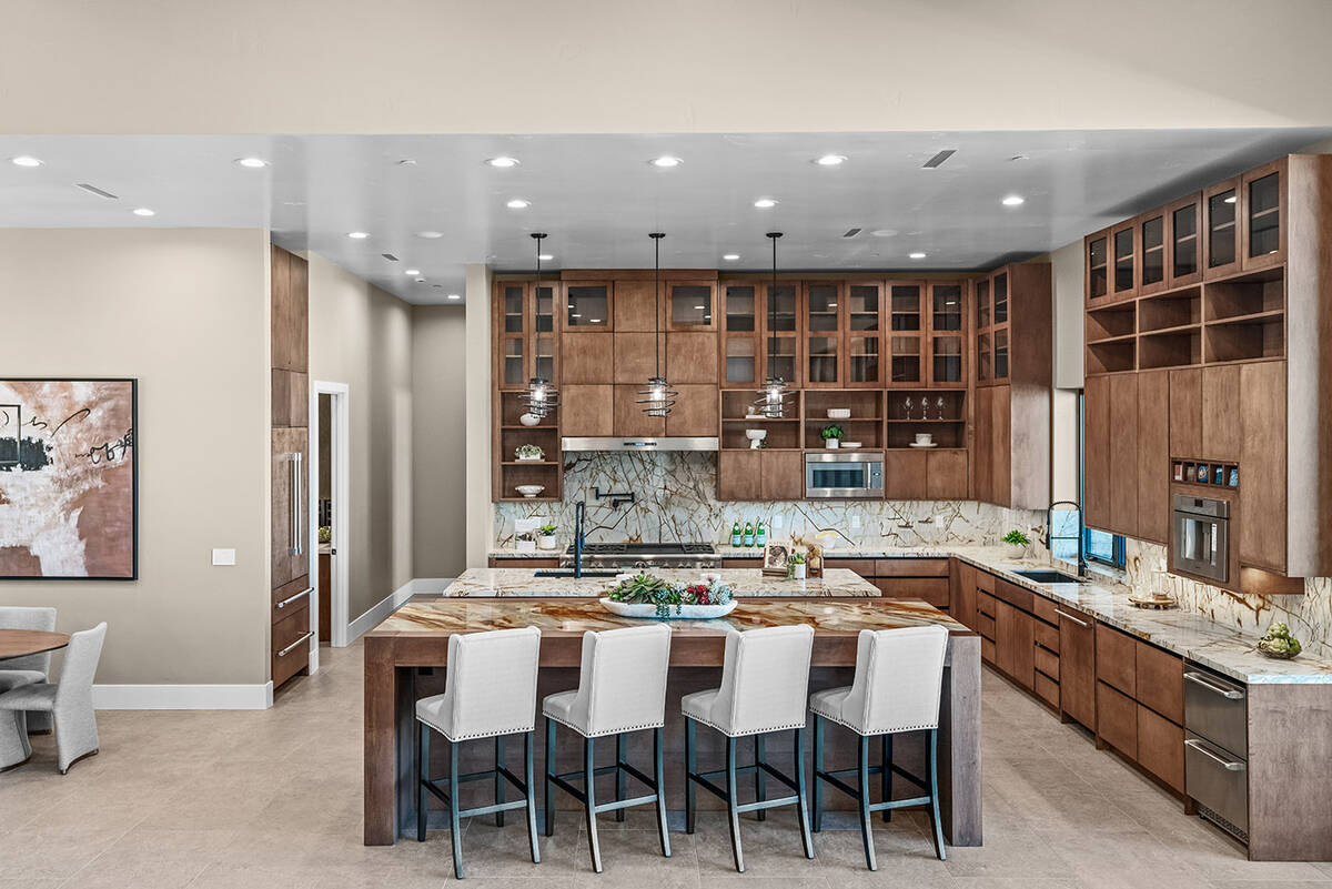 The culinary space is defined by natural stone, with eye-catching, bold veining and dramatic pa ...