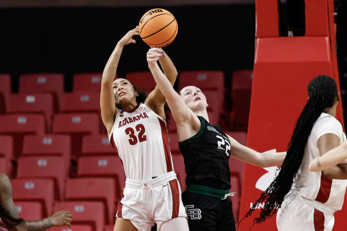 Alabama guard Aaliyah Nye (32) competes for a rebound against Green Bay guard Bailey Butler (22 ...