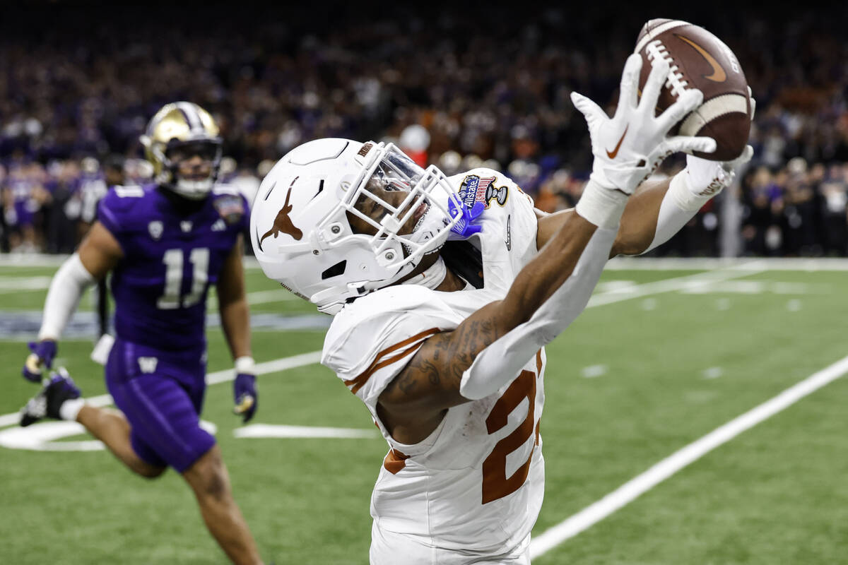 Texas defensive back Jahdae Barron (23) makes the catch against Washington during the second ha ...