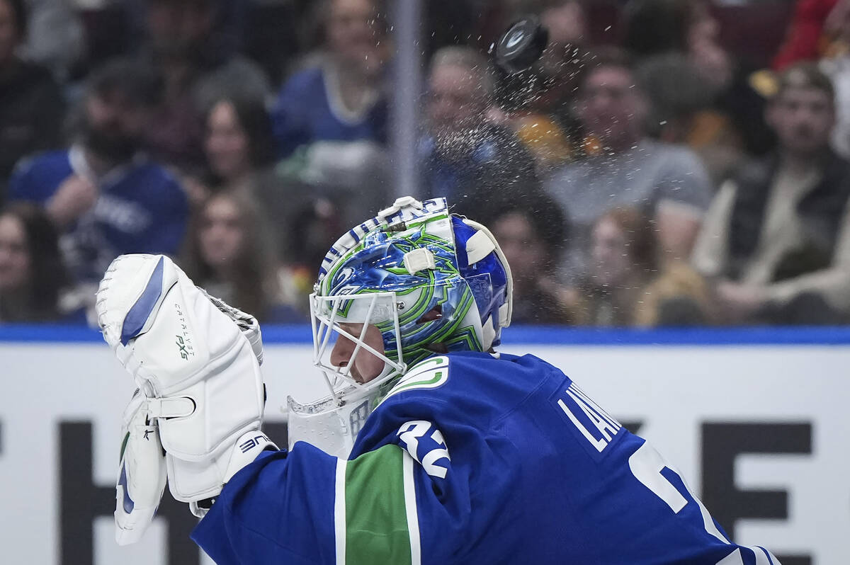 Vancouver Canucks goalie Kevin Lankinen makes a save during the first period of an NHL hockey g ...