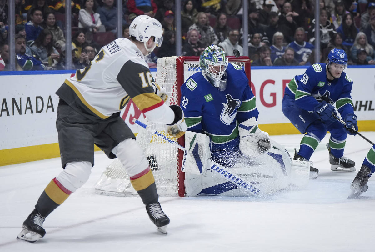 Vancouver Canucks goalie Kevin Lankinen (32) stops Vegas Golden Knights' Pavel Dorofeyev (16) d ...