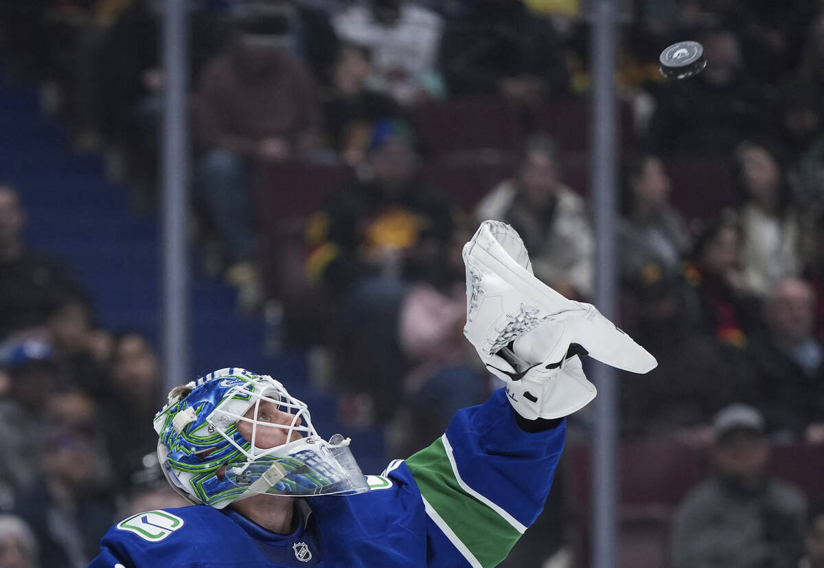Vancouver Canucks goalie Kevin Lankinen catches the puck during the second period of an NHL hoc ...