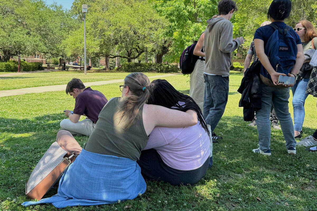 People comfort each other on Florida State University’s campus in Tallahassee, where law enfo ...