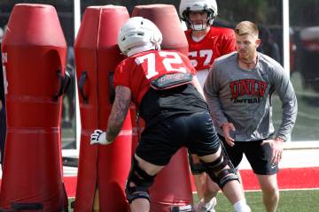 UNLV football offensive line coach Mike Sollenne watches as offensive line Will Thomas (72) goe ...