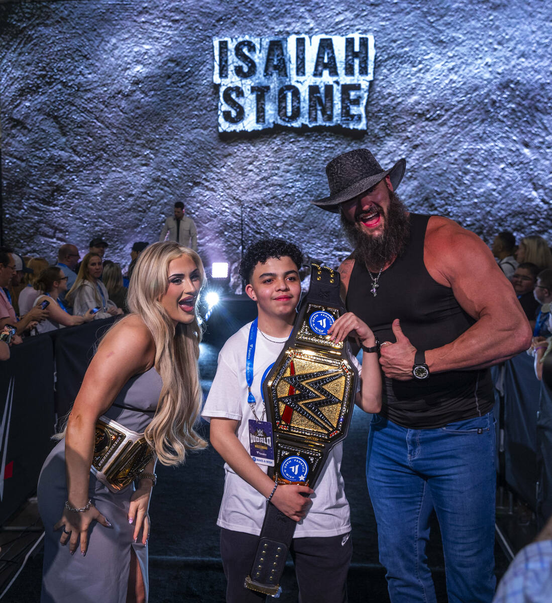 Make-A-Wish kid Isaiah "Stone" Nieves holds his title belt with wrestlers Tiffany Str ...