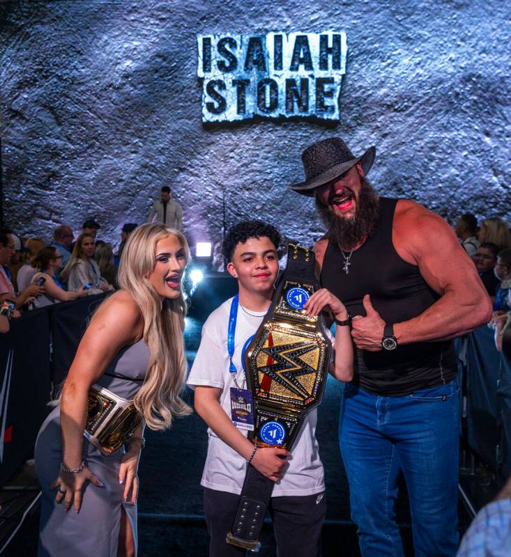 Make-A-Wish kid Isaiah "Stone" Nieves holds his title belt with wrestlers Tiffany Str ...