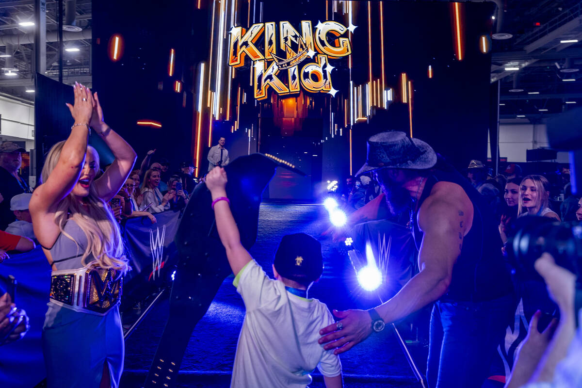 Make-A-Wish kid "King Kid" holds his title belt with wrestlers Tiffany Stratton and B ...