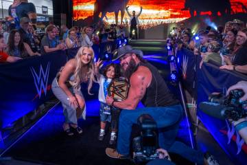 Make-A-Wish kid "The Mighty Rebel" holds his title belt with wrestlers Tiffany Stratt ...