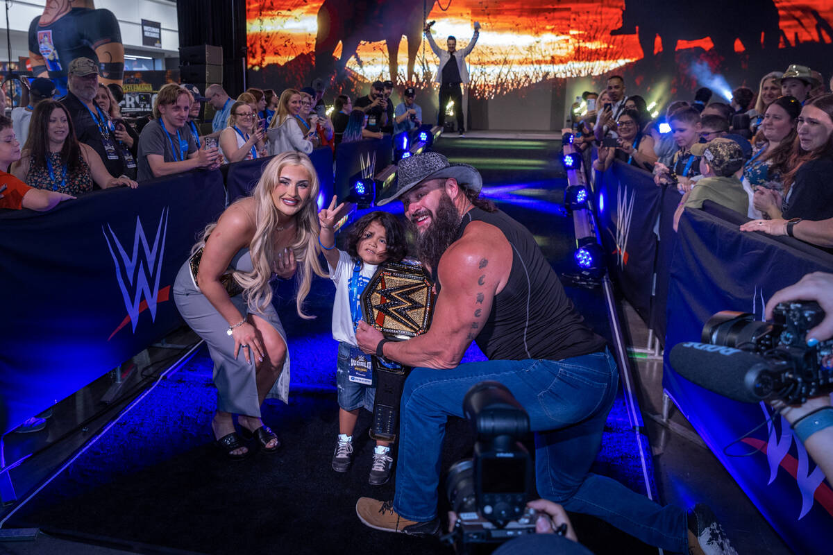 Make-A-Wish kid "The Mighty Rebel" holds his title belt with wrestlers Tiffany Stratt ...