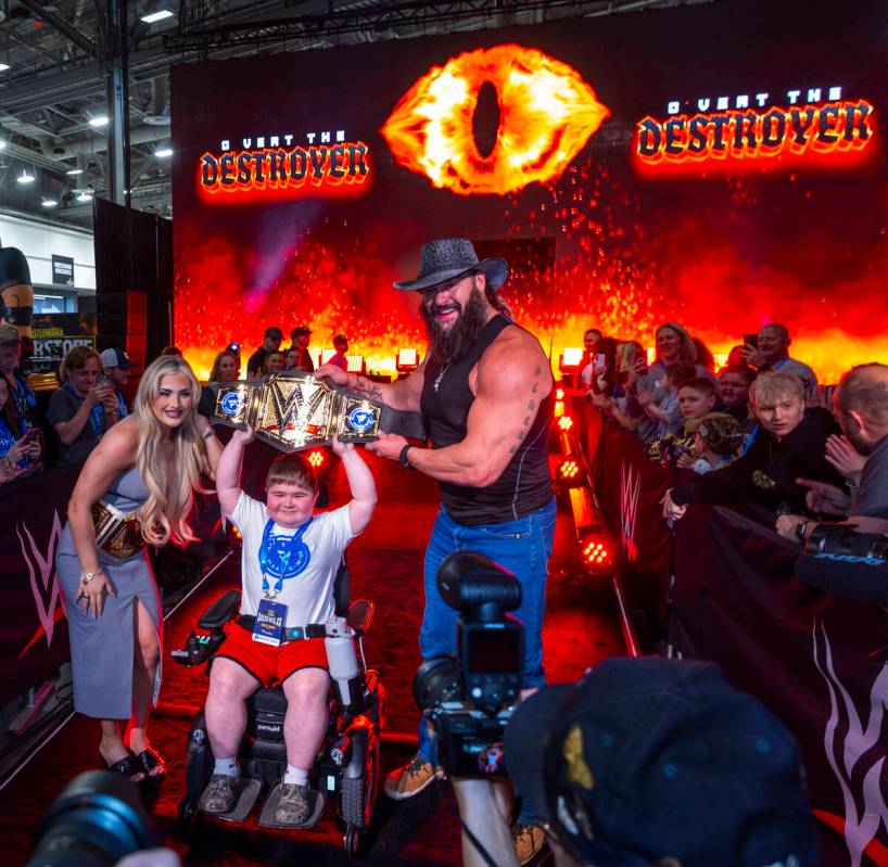 Make-A-Wish kid Charlie "C Vert The Destroyer" Vertin holds his title belt with wrest ...