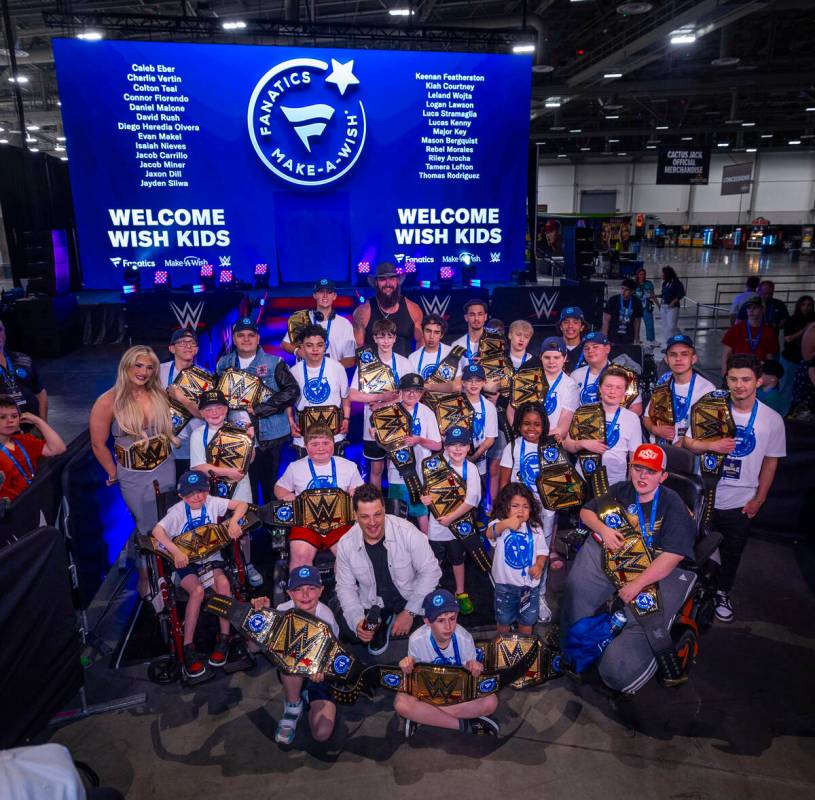 Make-A-Wish kids hold their title belts given to them by wrestlers as the organization and Fana ...
