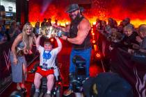 Make-A-Wish kid Charlie "C Vert The Destroyer" Vertin holds his title belt with wrestlers Tiffa ...