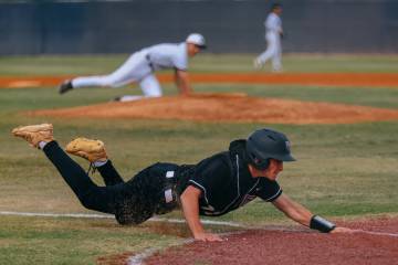 Desert Oasis’ Roenen Allen (11) slides toward home, earning the first run for the Diamon ...