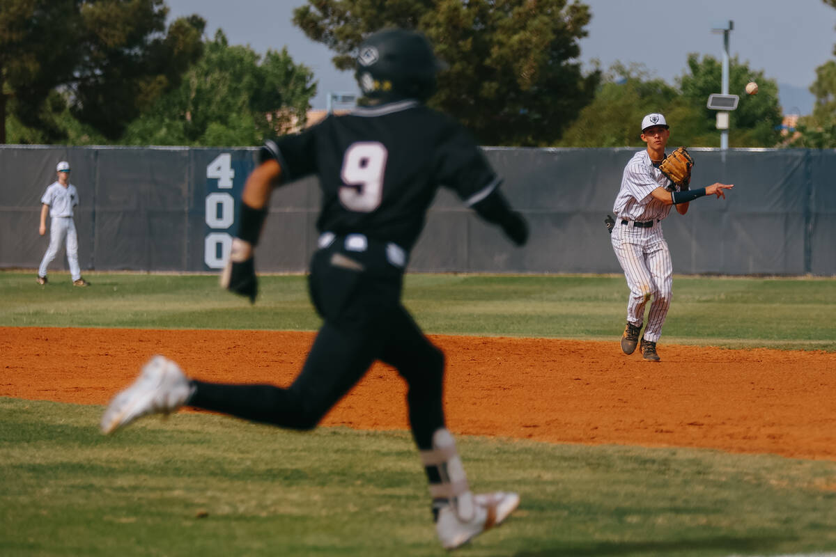 Spring Valley second baseman Keegan Cushenberry (23) throws toward first as Desert Oasis’ Jay ...