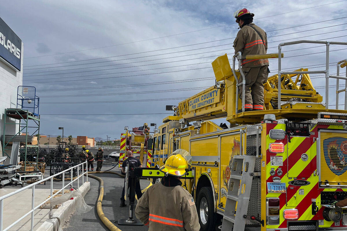 Clark County Fire Department crews work to extinguish a fire at RideNow Powersports near the co ...