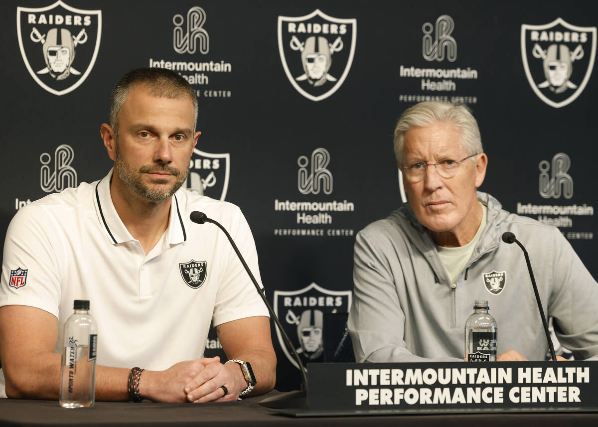 Raiders head coach Pete Carroll and General Manager John Spytek listen to reporters questions d ...