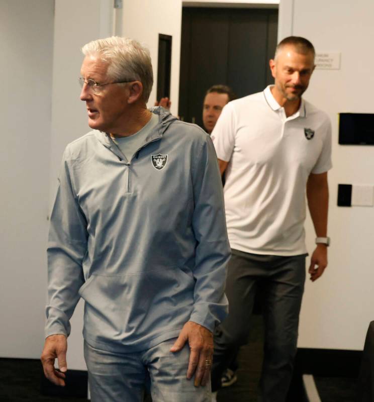 Raiders head coach Pete Carroll and General Manager John Spytek enter a media room to speak at ...