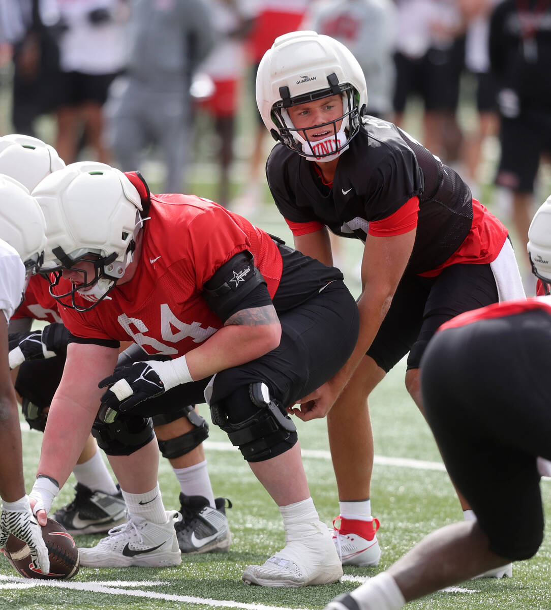 UNLV quarterback Anthony Colandrea (10) prepares to take the snap from offensive lineman Reid W ...