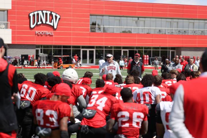 UNLV coach Dan Mullen talks to his team after a scrimmage at Bill 'Wildcat' Morris Rebel Park i ...